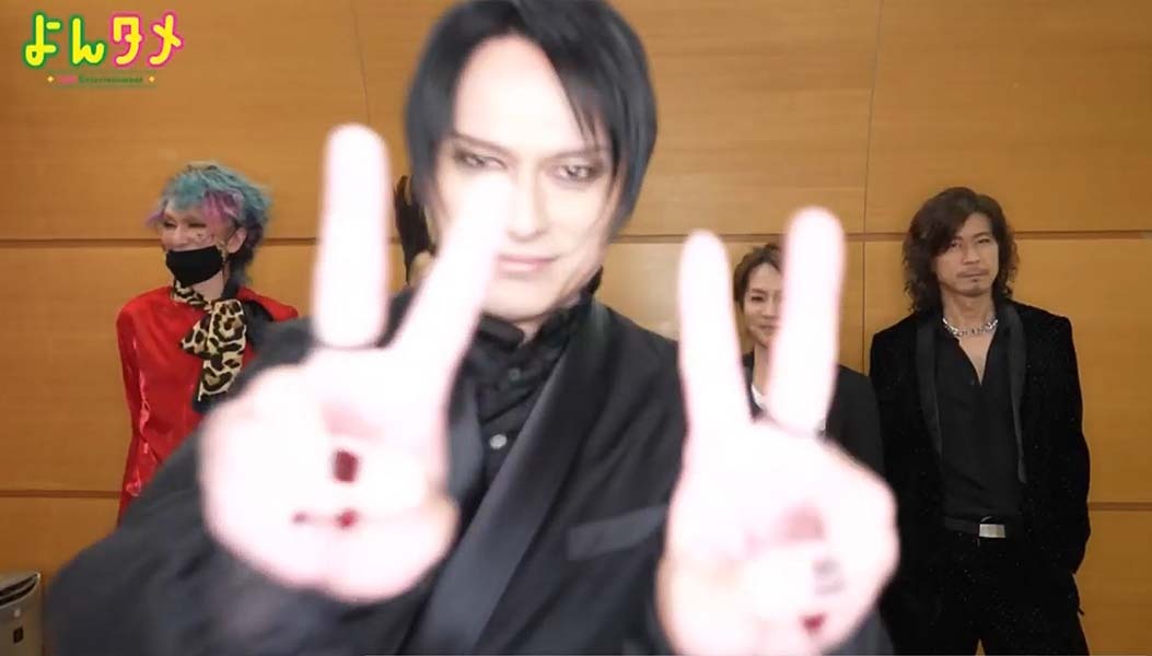 Atsushi Sakurai doing a peace sign